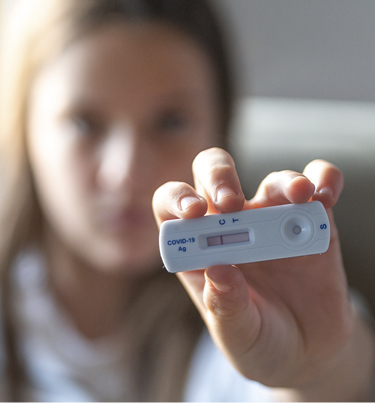 girl showing covid test result