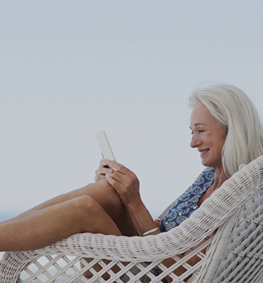 Woman sitting on seat looking at mobile