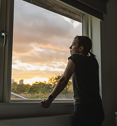 Woman looking out of window