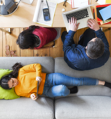 Birds eye view of people looking at computer and mobile screens