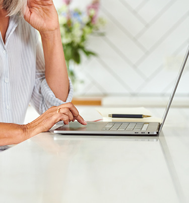 Woman pressing keys on laptop