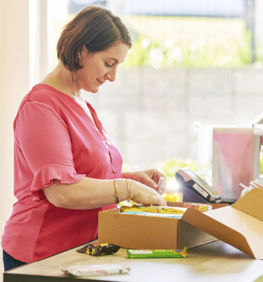 Woman packing courier box