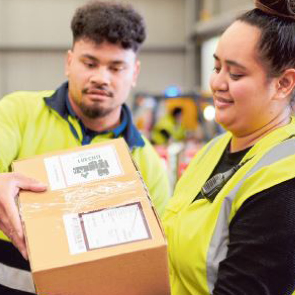 Man and women in hi-viz handling parcels