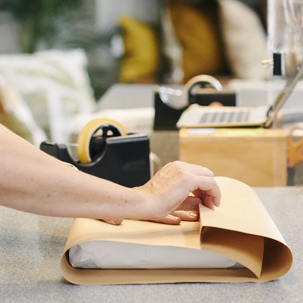 Woman wrapping courier package