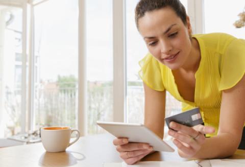 Woman holding tablet and credit card