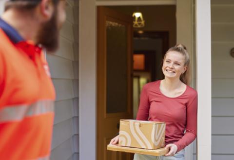 A woman holding courier packages