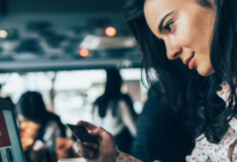 Woman looking at credit card