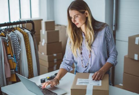 Retailer at computer fulfilling order