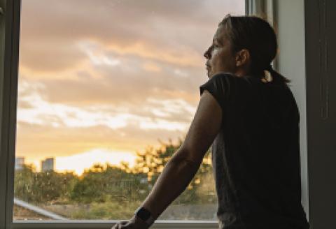 Woman looking out of window