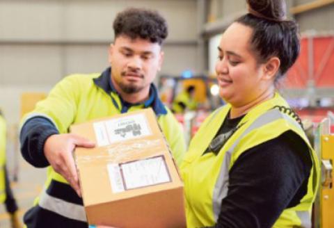 Man and women in hi-viz handling parcels