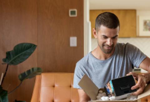 Man looking down at courier package