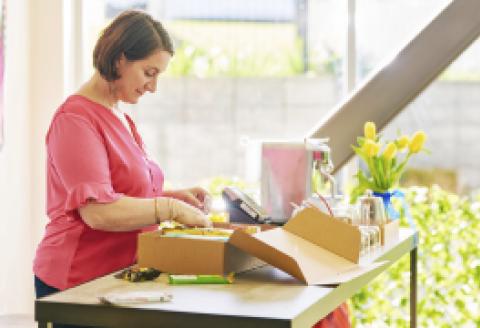 Woman packing courier box