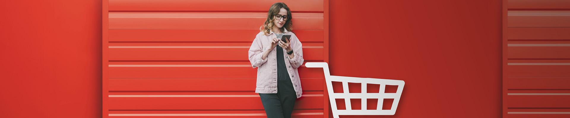 Woman leaning against garage door looking at mobile