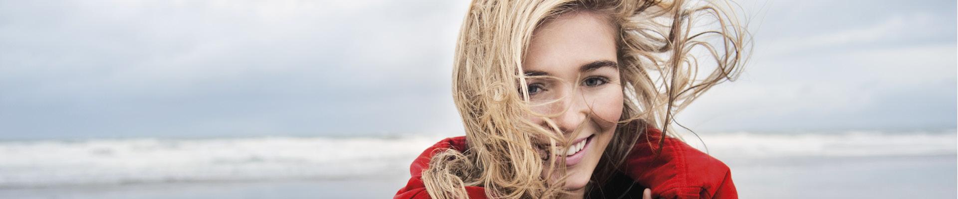 Woman laughing on beach