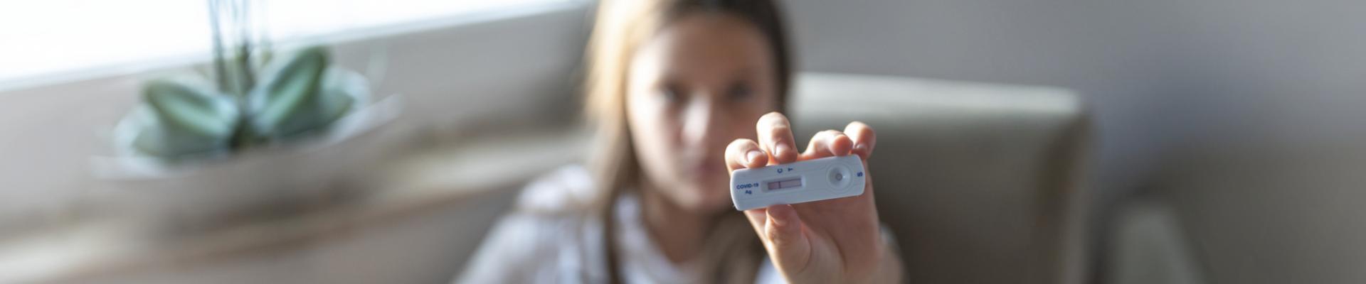 girl showing covid test result