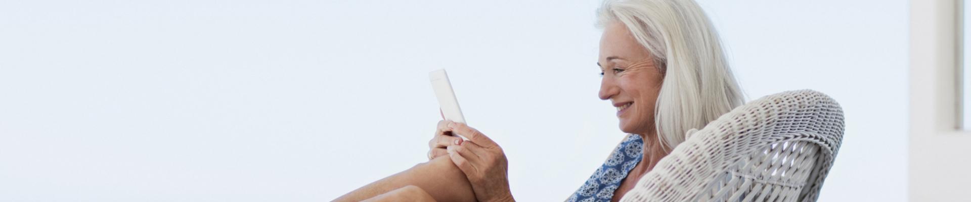 Woman sitting on seat looking at mobile