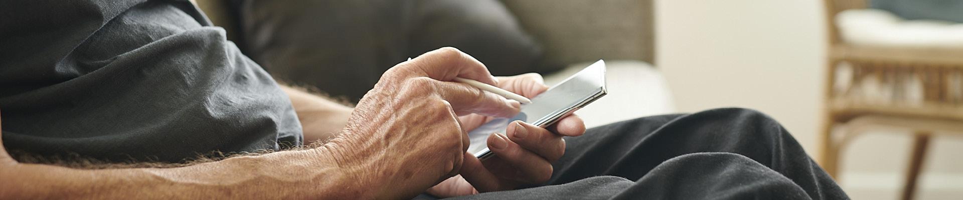 Gentleman sitting on couch using mobile phone