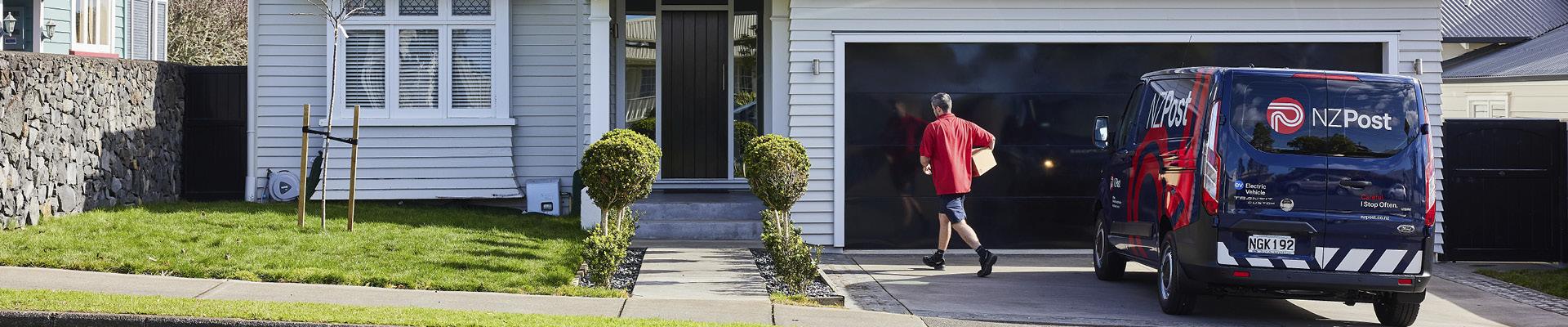 NZ Post courier van in driveway delivering parcel