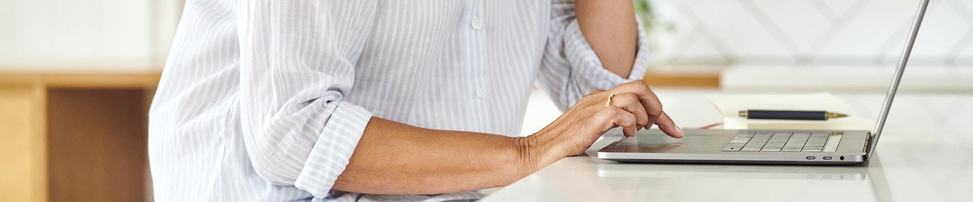 Womens hands using laptop