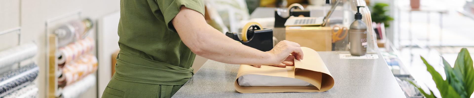 Woman wrapping courier package