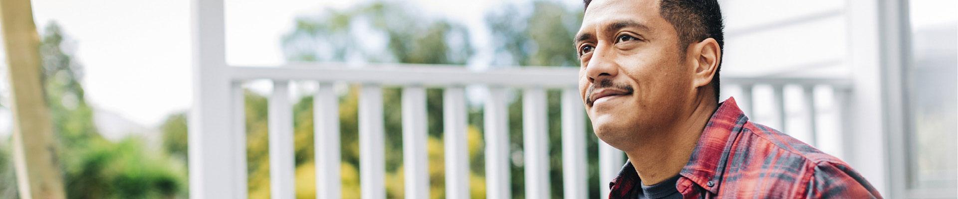 Man sitting on porch looking out