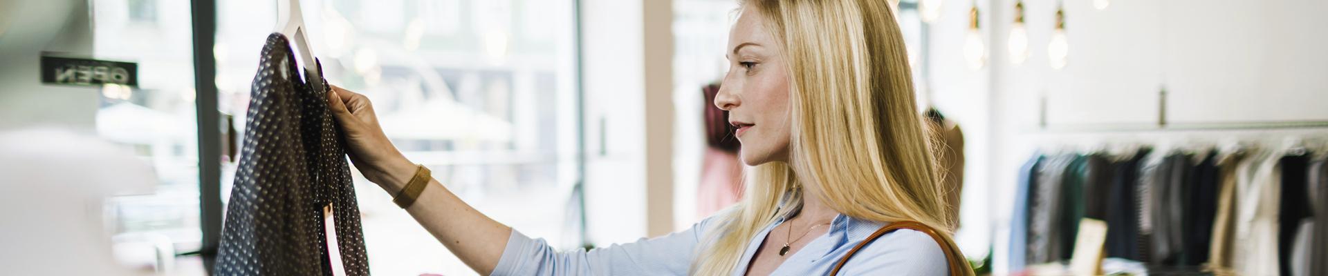 Woman shopping in store, looking at clothes