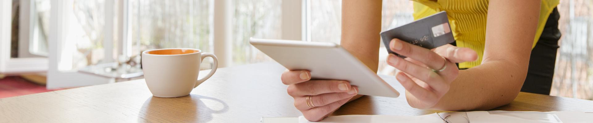 Woman holding tablet and credit card